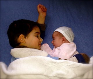 Bonding with his new baby sister